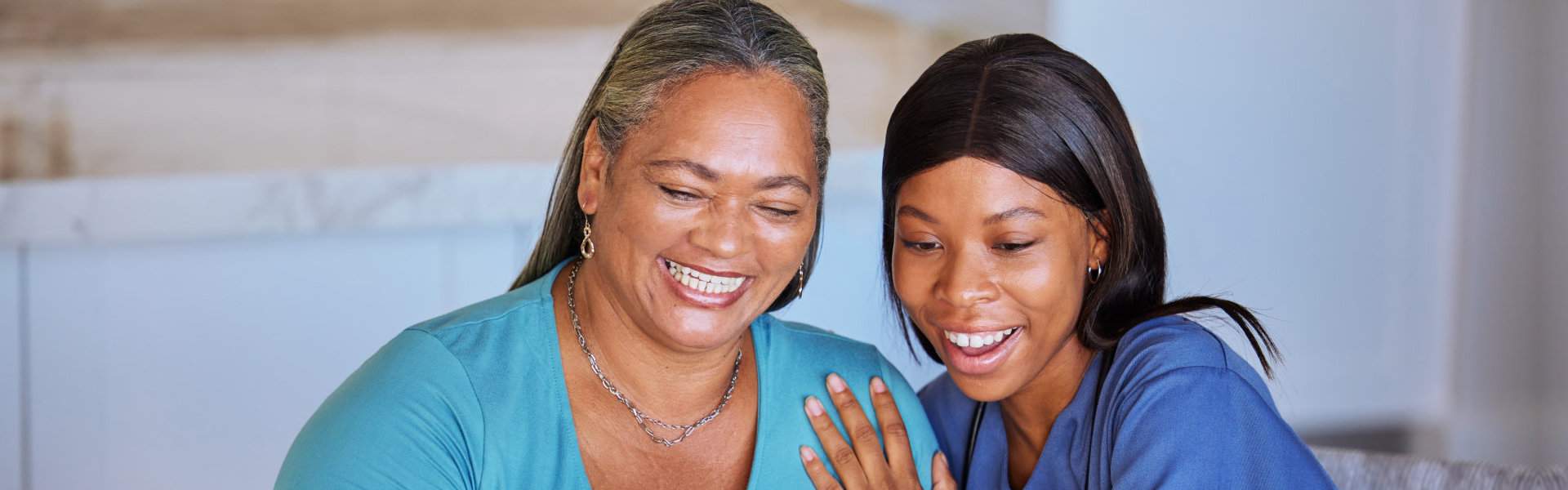 happy elderly woman with caretaker